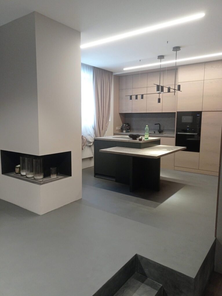 Modern kitchen interior with seamless Silk Plaster microcement floor and kitchen island